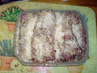 All the meat strips, tightly packed and covered with the curing mixture.